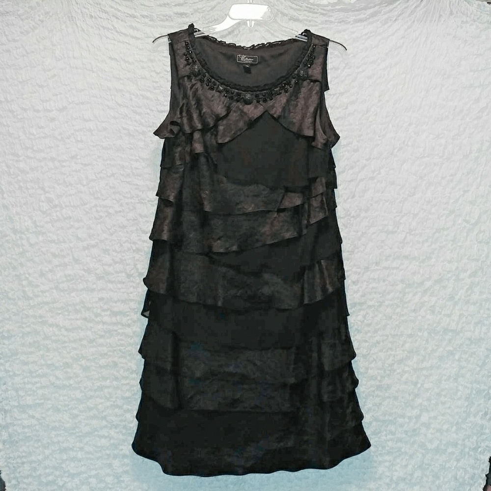 Black, mid-length, sleeveless, ruffle dress